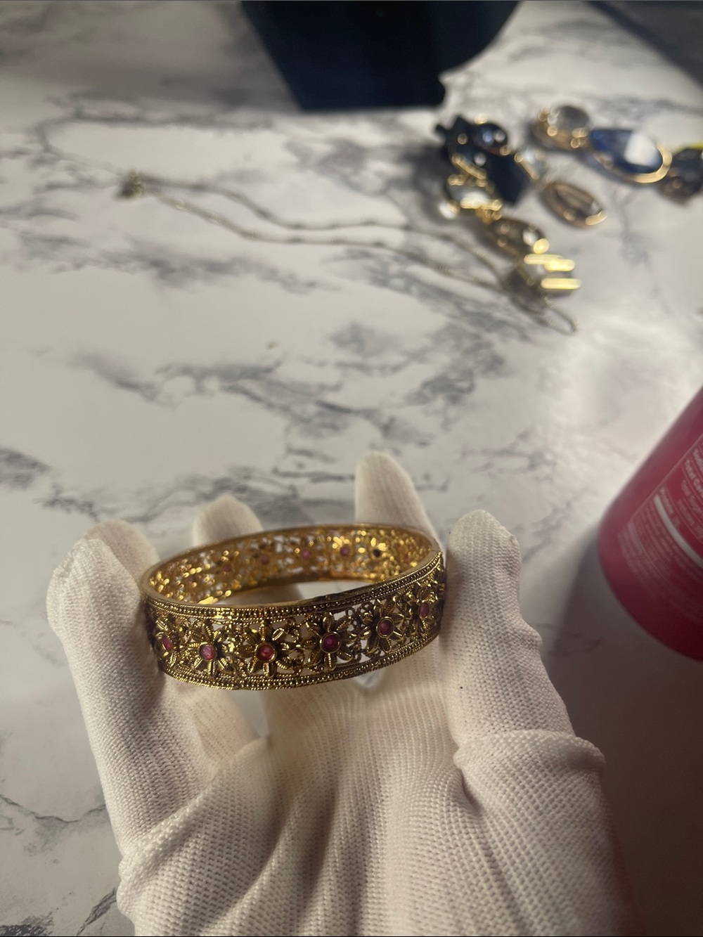 Gold-Tone Filigree Bangle with Pink Stone Accents